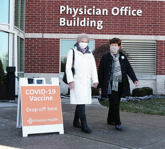 Dottie Wettstone, left, and Ruth Jenkins, exit Upper Valley Medical Center on Tuesday after receiving their COVID-19 vaccinations at the first Miami County Community Vaccine Clinic by Premier Health. Tuesday was the first “open” clinic for residents who fall into the priority protocols set up by the Ohio Department of Health.